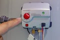 A person adjusting a gas control valve, residential gas water heater. Boiler Heating system