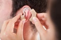 Person Adjusting Hearing Aid Royalty Free Stock Photo