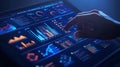 A person analyzes data visualizations on a tablet in a dimly lit space using interactive analytics tools Royalty Free Stock Photo