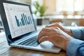 A person analyzes visual data on a laptop screen while seated at a wooden table. Generative AI Royalty Free Stock Photo