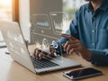 Person analyzing data on laptop with virtual interface displaying various charts and graphs Royalty Free Stock Photo