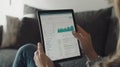 A person analyzing data on a tablet, displaying graphs and metrics Royalty Free Stock Photo