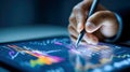 Person analyzing and interacting with colorful digital financial charts on a tablet using a stylus for data visualization and Royalty Free Stock Photo