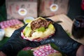 Person with arepa in hands, person eating a Corn arepas stuffed with beef, chicken breast, pork ham, mozzarella cheese and avocado