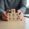 Person arranging wooden blocks symbolizing new ideas creative thinking brainstorming and problem solving Royalty Free Stock Photo