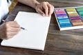 Person, artist painting with a pastel crayon chalk on a white sheet of paper.box with pastel chalks Royalty Free Stock Photo