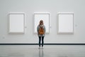 Art Gallery Mockup with Woman Viewing Blank Frames Royalty Free Stock Photo