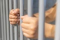 A person behind bars on a jail cell incarcerated Royalty Free Stock Photo