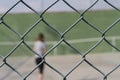 Person behind a metal fence