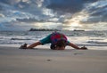 Photo of a person bending over on the beach