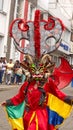 Person in a black devil mask with a headdress