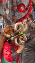 Person in a black devil mask with a headdress