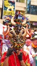 Person in a black devil mask with a headdress