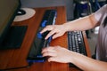 Person with blindness disability`s hands using computer with braille display or braille terminal a technology assistive device fo