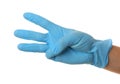 Person in blue latex gloves showing number three against white background, closeup on hand Royalty Free Stock Photo