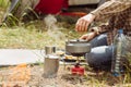 A person boiling water over a propane stove to make tea Royalty Free Stock Photo