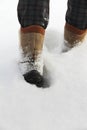Person in boots goes on a deep snow
