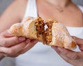 Person breaking a delicious mexican pan de muerto, day of the dead, delicious, spongy, inside a coffee shop, life style Royalty Free Stock Photo
