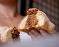 Person breaking a delicious mexican pan de muerto, day of the dead, delicious, spongy, inside a coffee shop, life style Royalty Free Stock Photo