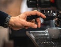 Close-up of Hand Operating Coffee Machine in Cafe Setting Royalty Free Stock Photo
