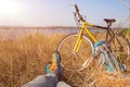 Person in bright sporty Shoes resting on Grass along Bicycle