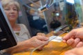 Person buying movie tickets from female seller at cinema