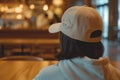 person at a caf wearing a casual 3d printed cap with a unique logo Royalty Free Stock Photo