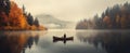 person in canoe floating in a lake with autumnal scenery