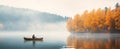 person in canoe floating in a lake with autumnal scenery