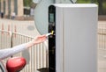 Person inserting into or removing ticket from parking machine.