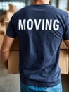 Person carrying boxes during moving day, logistical scene. Royalty Free Stock Photo