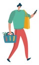 Person carrying groceries and holding phone. Modern consumer