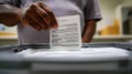 person is casting ballot into voting box, emphasizing civic engagement and democratic process. image captures importance of Royalty Free Stock Photo