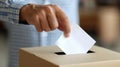 Person casting a vote into a ballot box during an election. Royalty Free Stock Photo