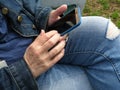 Person In Casual Jeans Texting In Cellphone Royalty Free Stock Photo