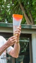 Person reading a measurement in a rain gauge Royalty Free Stock Photo