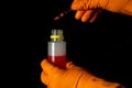 Person chemist holds test tube of glass in his hand with acid. Mixing chemicals