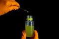 Person chemist holds test tube of glass in his hand with acid. Mixing chemicals for experiment