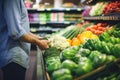 Person choosing fresh vegetables in supermarket