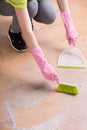 Person cleaning floor with dustpan Royalty Free Stock Photo