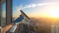 Cleaning a window with a squeegee and spray bottle at sunset Royalty Free Stock Photo