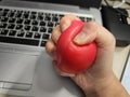 A person clench a stress ball to release anxiety and frustration