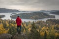 Person at cliff in Landscape panorama with islands of HÃ¶ga Kusten at the lookout point RÃ¶dklitten in Sweden in autumn Royalty Free Stock Photo