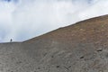 Person climbing on Mount Etna Vulcano Silvestri crater Royalty Free Stock Photo