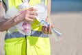 Close Up Of Person Collecting Plastic Waste From Polluted Beach