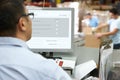 Person At Computer Terminal In Distribution Warehouse Royalty Free Stock Photo