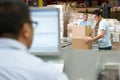 Person At Computer Terminal In Distribution Warehouse