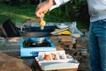 Person cooking eggs on camping stove Royalty Free Stock Photo