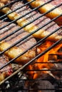 Person cooking steaks on a barbecue grill