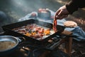 person, cooking warm meal of scrambled eggs and bacon on camping stove